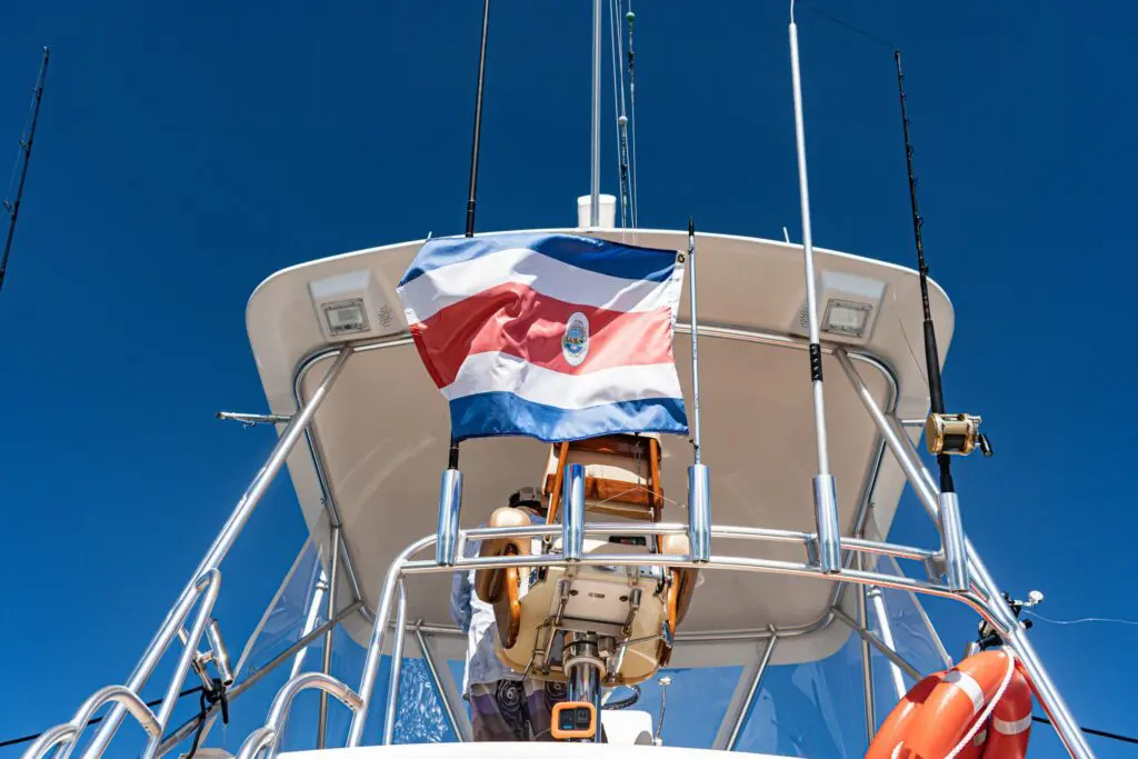 Costa Rica flag flying on a premium sportfishing charter boat under a clear blue sky